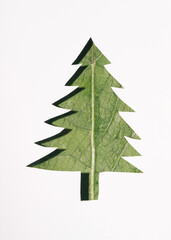 Environment Care Concept.  Layers of Paper Cut as Green leaf Texture Surface in shape of Christmas tree. Earth Day and Ecology.