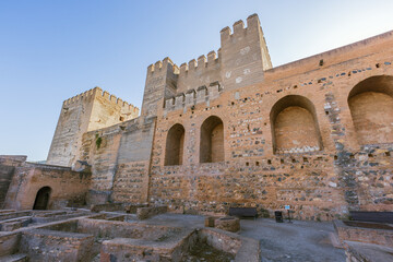 Naklejka premium Inside of the Alcazaba with the tower of tribute and the ruins of the military barracks on the foreground