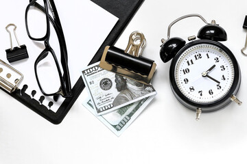 Obraz na płótnie Canvas alarm clock and money on a white background close-up. concept as investment, finance, account and stock market