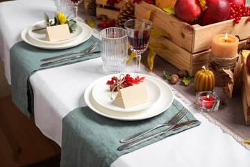 Beautiful autumn place setting with blank cards and decor on table