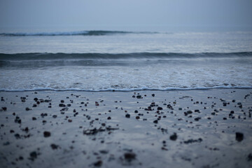Pebbles on beach with small wave