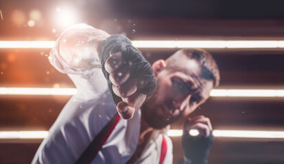 Images of a bearded man in a white shirt and red suspenders in the ring. The concept of fist...