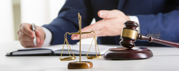 Lawyer working with contract papers and wooden gavel on tabel in courtroom. justice and law ,attorney, court judge concept.