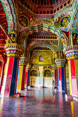 Fototapeta na wymiar Thanjavur, Tamil Nadu, India - The high arches artworks and colorfully painted wall murals and ceilings of the ancient 17th-century durbar hall Maratha Palace in the town of Thanjavur