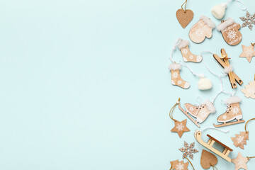 Winter Christmas composition with wooden decorations ornaments on a blue background. Flat lay top view copy space frame border.