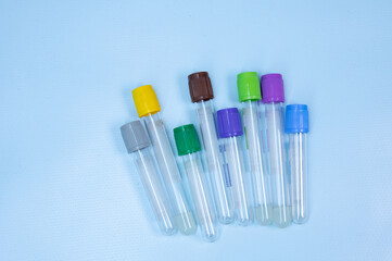 Vacuum tubes for collection and blood samples with sodium citrate EDTA heparin fluoride anticoagulant for laboratory on blue background