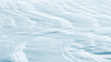 Fototapeta na wymiar Snowy abstract background. Natural patterns in the snow.