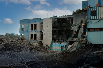 ruined house with empty windows, broken brick, cracks on the wall of a dilapidated building, the concept of ruin of people, business collapse due to Social problems, poverty, Low income, Urban decay