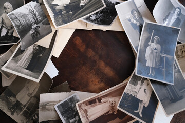 on an old wooden table there are old photographs of 1950-1960, , concept of family tree, genealogy, childhood memories, connection with ancestors