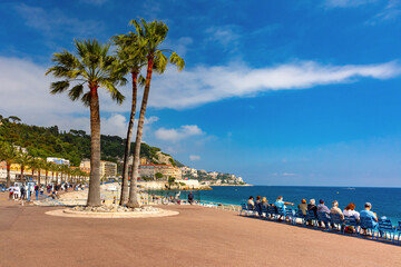 South sidewalk witn blue chairs of Promenade des Anglais in Nice, French Riviera, France - obrazy, fototapety, plakaty