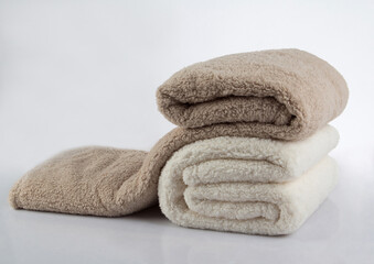 Fototapeta na wymiar Soft and warm stack of folded blankets isolated on white background