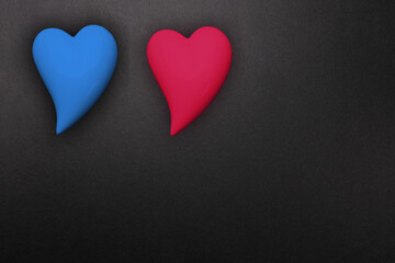 two hearts red and blue on a black background, a symbol of love, the basis for the designer, wallpaper, gift wrapping, valentine's day background