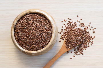 Flax seeds on wooden background