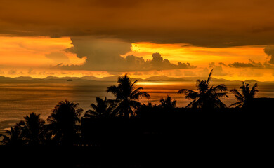 orange sunset on islands with big silhouette and clouds