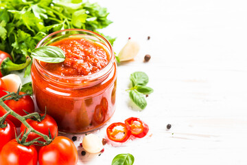 Tomato sauce. Traditional italian tomato sauce with ingredients at white background.