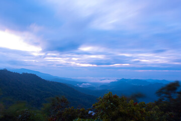 The sun rises on a high mountain with clouds