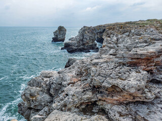 Fototapeta na wymiar Breaking waves on the rocky coast of the Black Sea