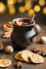 Christmas mulled wine from red wine with fruits and spices on the village table. Traditional hot winter drink.