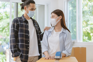Crisis, Stressed  business due to outbreak of coronavirus, asian young couple wear mask moving new relocation, home no money pay expense mortgage, loan. Unemployed, loss job or debt, bankrupt people.