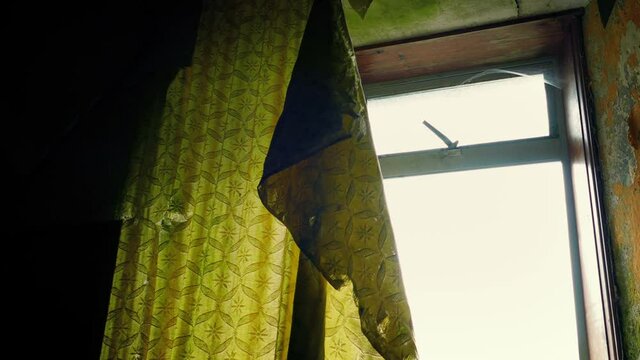 Run Down House With Old Curtain By Window