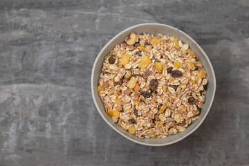 dry muesli with dry fruits in small bowl