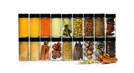 Various spices in glass jars on white background
