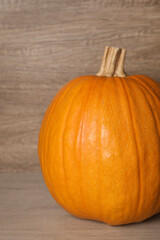 Fresh ripe pumpkin on wooden table, closeup