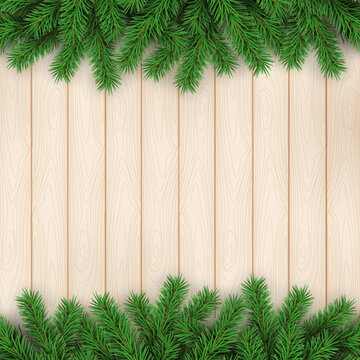 Christmas holidays. Pine branches on wooden texture background
