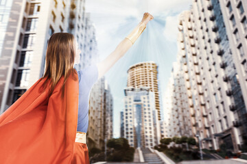 Woman wearing superhero costume and beautiful cityscape on background