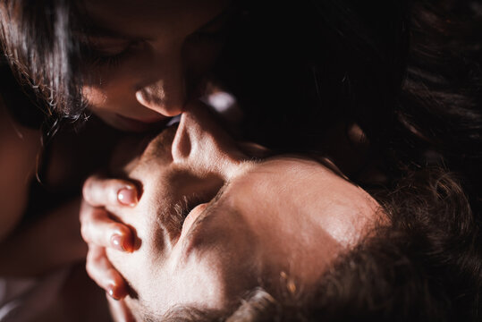 Close Up View Of Woman Kissing Young Man With Closed Eyes