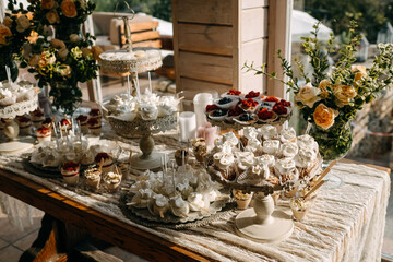 Candy bar table setting with flower decorations at a wedding.
