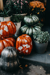 painted pumpkins and flowers decorations at a cafe.