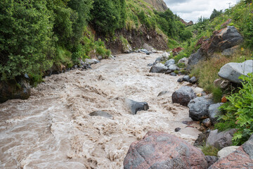 Close-up of a large turbulent flow of water in the river. A mountain river carries its waters...