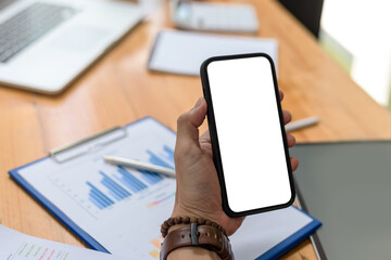 Close-up of a businesswoman hand holding a smartphone blank white screen enjoy social media applications ads. Mock up.