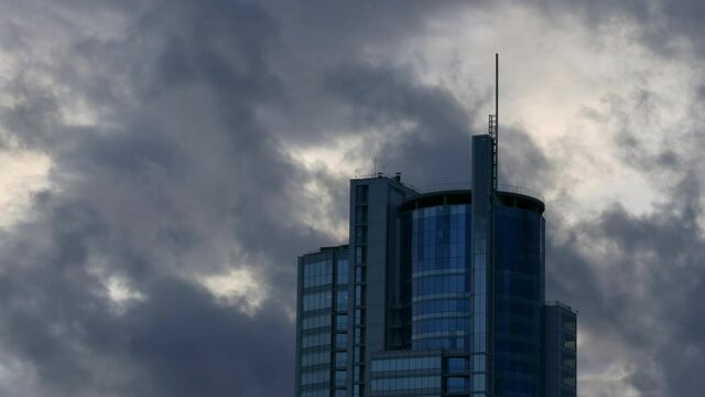 Skyscraper building / Corporate building / Clouds and Sky. Gray commercial skyscraper against dramatic sky background.

Unmodified camera color.