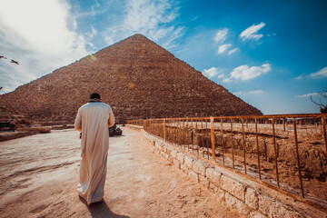Arab man in traditional dress near the pyramid in Giza
