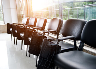 Row of chairs in boardroom.