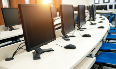 Group of computer neatly placed in a computer lab.