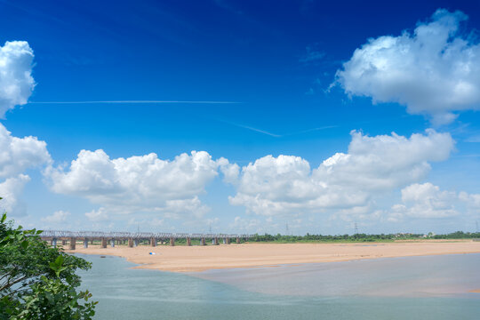 Beautiful landscape sccenic image of Mahanadi river of Odisha, with blue sky and white clouds in the background. Nature stock image of Odisha , India with copy space.