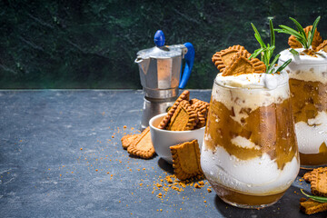 Biscoff coffee latte with cookie pasta, whole cookies, whipped cream and rosemary decor 