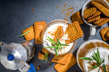 Biscoff coffee latte with cookie pasta, whole cookies, whipped cream and rosemary decor 
