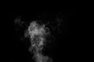 Fragment of white hot curly steam smoke isolated on a black background. Create mystical Halloween photos.
