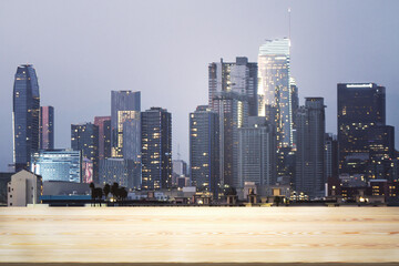 Blank wooden tabletop with beautiful Los Angeles skyline at night on background, mockup