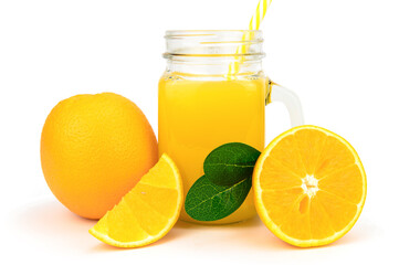 A jar of orange juice with a straw next to an orange, an orange half and a slice
