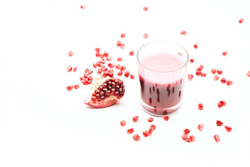 Pomegranate juice in a glass on white background