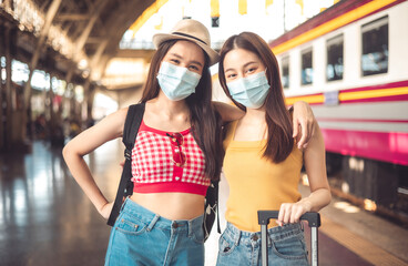 Woman traveler with bag, luggage, arrival during traveling, travel, trip for woman concept, say hi, good bye to friend.trip in summer with face mask for protection by infection from Coronavirus.
