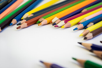 Multicolored pencils on a white table.