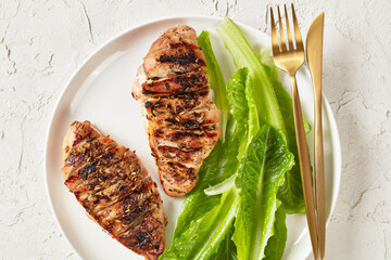 seared chicken breasts with romaine lettuce leaves