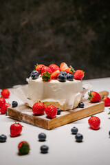 Confectionery on white background, strawberry blueberry cake