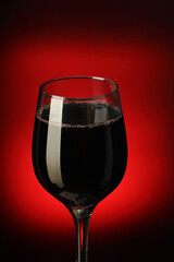 goblet full of wine over black background
